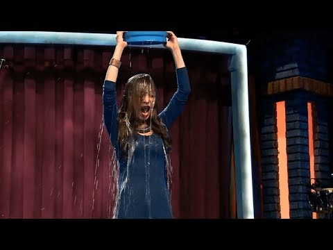 Two women soaked with water buckets